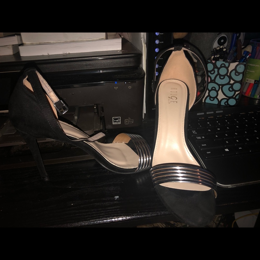 Black high heels w/ silver strap over toes